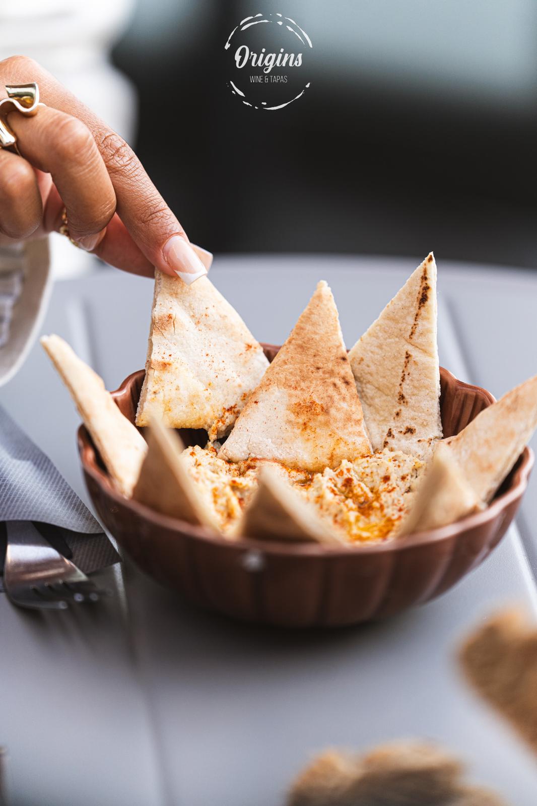 Hummus dusted with paprika and olive oil, served with warm pita triangles